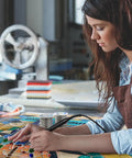 Woman working on stained glass art using a soldering iron, with Leaded 60 40 Solder For Stained Glass In 4 Lb Pack Industrial Grade Tin Lead Wire