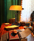 Amber Glass Bankers Desk Lamp With Retro Weighted Base And Old School Vibe on vintage desk with typewriter, E26 Base, matte orange shade