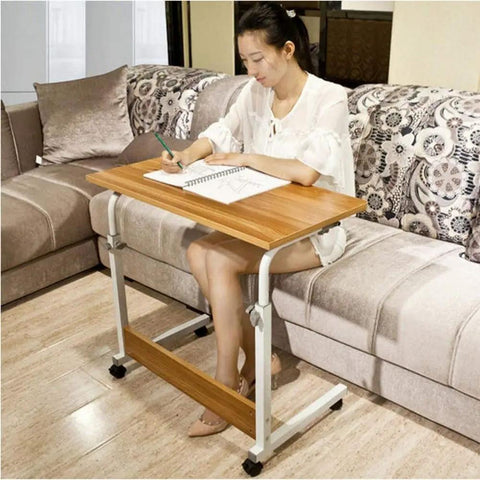 Height Adjustable Rolling Laptop Stand With Locking Wheels Folds Flat For Bed Or Couch used for writing on a couch.