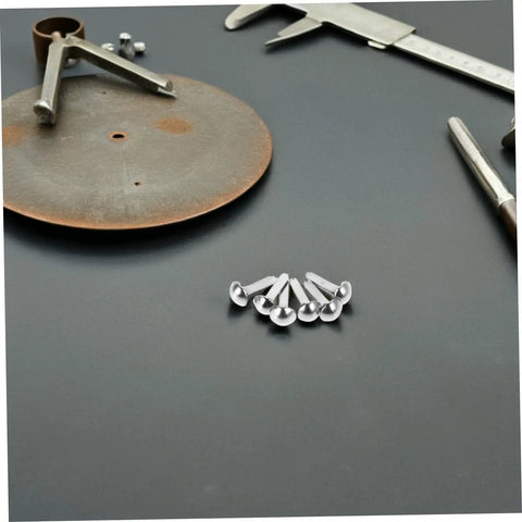 Mini Iron Brads For DIY Projects 100 Pack Paper Craft Fasteners For Shadow Puppet Making Kit And Scrapbooking Embellishments Repairs Metal Fasteners For Craft Junkies arranged on a table with tools