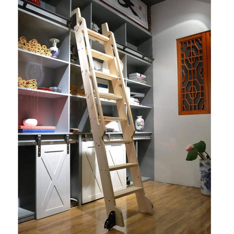 Wooden library ladder leaning against a shelving unit with white sliding barn doors and decorative items.