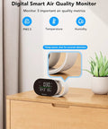 Smart Air Quality Monitor With PM2.5 Sensor, WiFi, Temperature And Humidity Tracking on a wooden dresser next to a plant