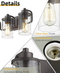 Close-up of three light farmhouse vanity light fixture for bathroom wall mount in oil rubbed bronze with clear glass shades.