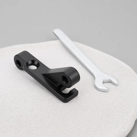 IS Mount To Flat Mount Brake Adapter For 160mm Rear Or 180mm Front Rotors next to a metal wrench on gray surface