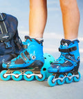 Close-up of person wearing blue inline skates with Must-Have 2 Pack Inline Skate Strap Replacement Kit With Adjustable Buckles.