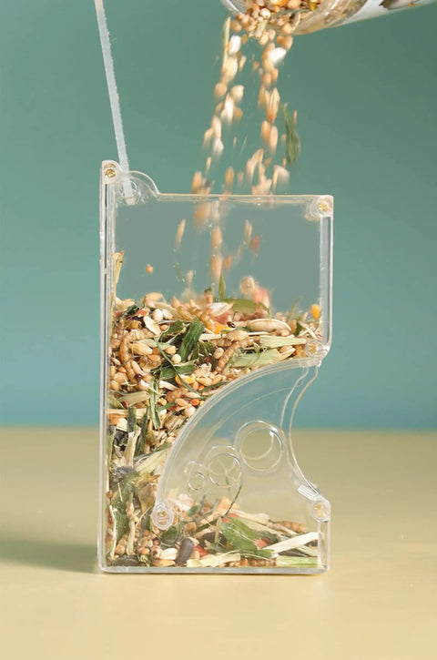 Top Rated Two Piece Automatic Hamster Feeder With Sturdy Wall Mount Brackets And Wide Mouth Design filled with mixed seeds.