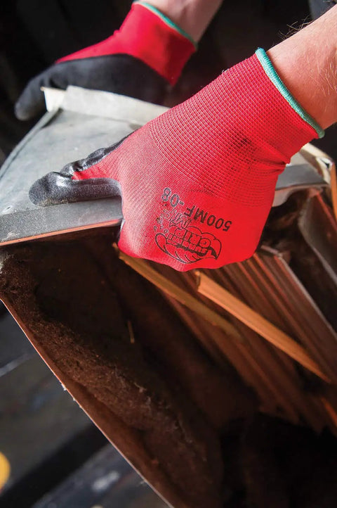Person wearing Tsunami Grip Mach Finish Nitrile Coated Gloves With Double Dipped Micro Finish handling sharp metal.