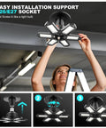 Woman installing 8 Pack Ultra Bright 120W LED Garage Light Bulbs, 12000 Lumens, 6500K Daylight, Screw In E26 E27 Base.