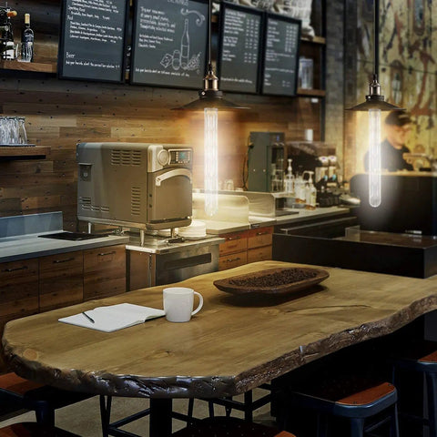 Retro Edison Look LED Filament Bulbs T10 Tubular 12W Dimmable in a cozy cafe setting with warm wood and modern decor
