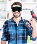 Kick Ass Flip Up Welding Goggles Heavy Duty Safety Glasses Rugged 2 Pack Welder Shades worn by a man holding a drill.