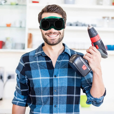 Kick Ass Flip Up Welding Goggles Heavy Duty Safety Glasses Rugged 2 Pack Welder Shades worn by a man holding a drill.