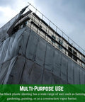 Building covered with 4 Mil Black Plastic Sheeting Roll 4 Ft By 100 Ft Heavy Duty Polyethylene Tarp For Painters And Construction Vapor Barrier