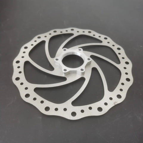 180mm Bicycle Disc Brake Rotor With Flange Adapter For Threaded Hubs Stainless Steel 2mm Thick Silver Finish on black surface