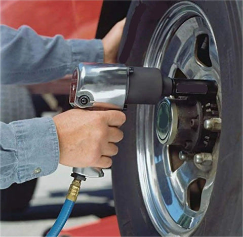 Using a Double Head Air Impact Wrench Half Inch Drive Pneumatic Ratchet 600Nm Torque on a tire for quick repairs.