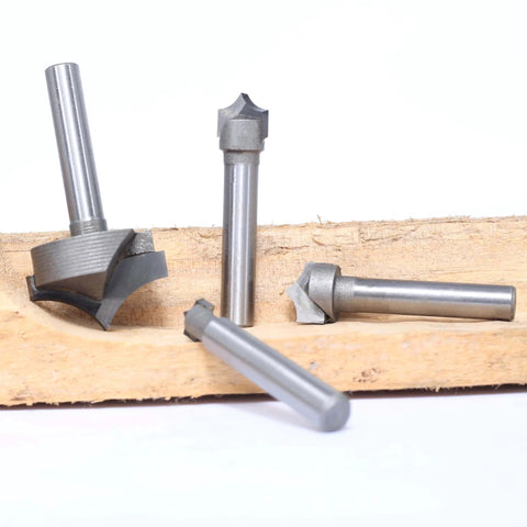 Four Piece One Quarter Inch Shank Roundover Plunge Router Bit Set With Three Eighths, Half And One Inch Cutting Diameters And Radii Of Three Sixteenths, One Quarter And One Half Inch For Wood Engraving, Sign Making, Relief Carving, 2D And 3D Carving displayed on wood surface.