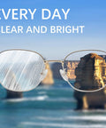 Eyeglasses with metal frames and reflective lenses against a seascape background.
