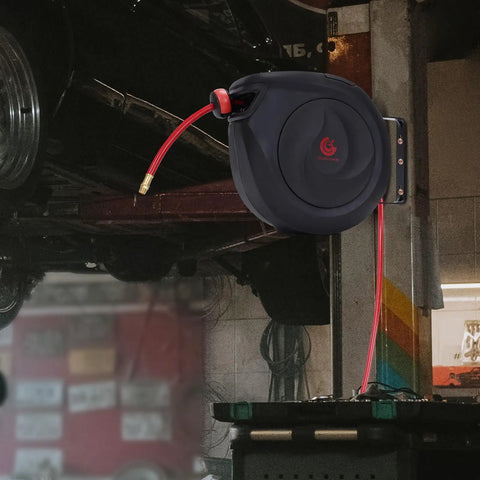 Heavy-Duty Retractable Air Hose Reel 50Ft 3/8 Inch Polymer Line Solid Brass Fittings mounted on a garage wall with hose extended