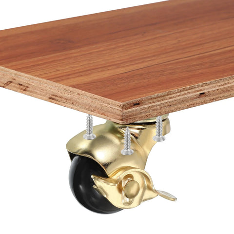 1.5 Inch Ball Caster Wheels With Brake, gold finish, mounted on wooden board, 360 degree swivel, includes M4 screws