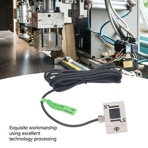 Heavy Duty S Beam Load Cell Sensor For Precision Force Measurement In Industrial Weighing Systems 100N Capacity With Tension And Compression Stainless Steel Transducer Built To Handle Tough Lab And Factory Applications shown next to industrial machinery.