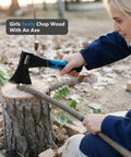 Woman using Rugged Workhorse 10 Inch Outdoor Hatchet for camping, forged carbon steel, blue non-slip grip, chopping wood