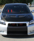 Front view of a car featuring 2005 To 2010 Scion tC LED Halo Projector Headlights Upgrade Kit with black housing and angel eye rings.