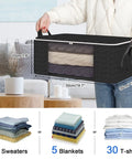 Person holding Set Of 8 Foldable Closet Storage Bags With Zippers And Clear Window, 36L for blankets and sweaters, black color.