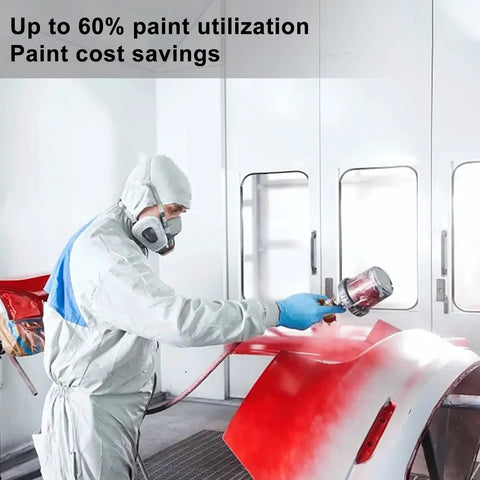 Painter using Pro Grade Paint Sprayer Kit With Quick Mixing Cup And HVLP Gun, applying red paint on car part in booth