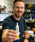 Man holding tube of Heavy Duty 3D Printer Lubricant Grease For Smooth Axis Guides Lead Screws Rods And Gears High Performance Silicone Oil