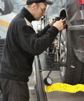 Top Tier Yellow PU Coil Air Hose With Quick Lock Connector For Air Compressor And Pneumatic Tools Delivering Rock Solid Durability High Pressure Hold And No Sweat Installation In A Smooth Five Meter Length, used while inflating a tire.