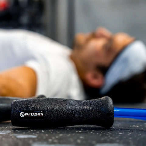 Muay Thai 2.0 Weighted Jump Rope For High Intensity Training And MMA Workouts, close-up of handle with blurred athlete