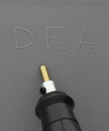 Electric Engraver With Carbide Tipped Point, 120V 60Hz, 7200 SPM engraving the word 'IDEAL' on gray surface
