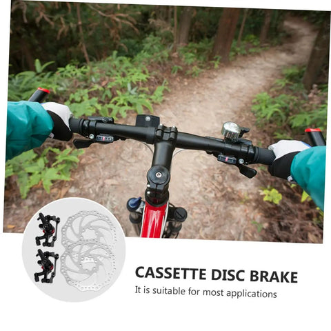 Bombproof Mechanical Disc Brake Rotor Kit For Mountain Bike Featuring Front And Rear 160 Mm Silver Rotors on mountain bike handlebars.