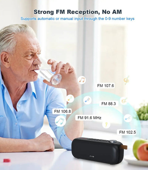 Bluetooth Speaker With FM Radio And 5 In 1 Music Player on table with FM bands; man drinking water in background.