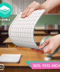 Hands holding Flexible Dry Erase Whiteboards For Multiplication Practice 9 By 12 Inches Pack Of 10 Sheets in classroom