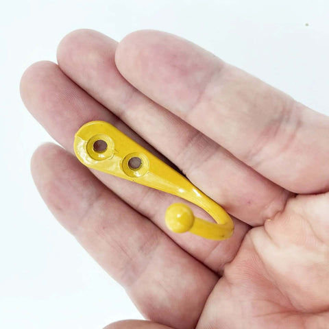 Built Tough Wall Mounted Hooks Set Of Four Premium Zinc Alloy Coat Hangers Bright Yellow for storage, showing one hook in hand.