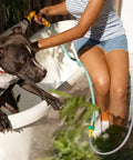 Woman using Heavy Duty 304 Stainless Steel Garden Hose 3ft Leakproof Flexible Leader Hose with dog in outdoor bath