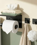 Toilet Paper Holder With Shelf And Towel Hooks Wall Mount Easy Install Adhesive Or Screw Mount Stainless Steel Matte Black Bathroom Organizer Kit With Phone Shelf Rust Resistant Dope Storage Solution holding toilet paper and wipe container.