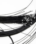 Close-up of Teflon Shift Cable Inner Derailleur Cables for mountain bike, road bike, BMX, showing 2100mm length and metal end caps.