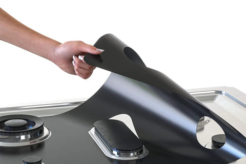 Person placing Custom Fit Gas Stove Top Cover Protector For Your Burner Area - Heat Resistant Up To 572 F - Nonstick Teflon Liner