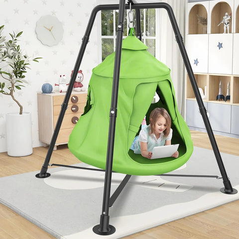 Child playing on an Outdoor Swing Set With Tent Swing And X Shaped Frame Sensory Swing indoors, featuring a green tent swing.