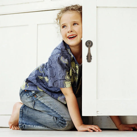 Child next to vintage cabinet with 10 Pack Dope Vintage Style Zinc Alloy Drawer Pulls With Single Hole Design For Easy Install And A Secure Fit