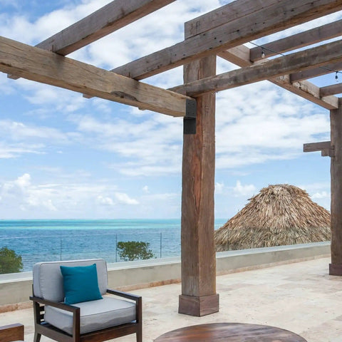 Outdoor pergola overlooking ocean view with wooden beams secured by 4 Piece Joist Anchor Connectors For 4x4 And 4x6 Wood Posts Heavy Duty Carbon Steel Mounting Brackets For Roofing Trusses To Beams Outdoor Pergola And Deck Support Rust Resistant Weatherproof Construction.