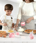 Adult and child cooking with pink Stackable Measuring Cups And Spoons Set 10 Piece With Stainless Steel Handles in kitchen.