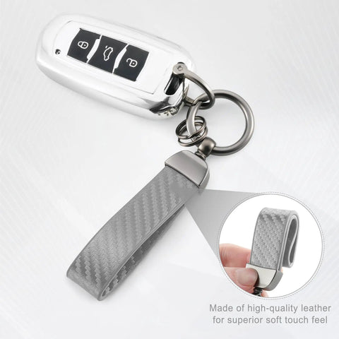 Premium Genuine Leather Car Keychain Featuring Slick Carbon Fiber Wrap And Anti Lost D Ring Built On Solid Zinc Alloy Base With Dual Split Rings For Everyday Ride Gear In Sharp Grey Finish, close-up view showcasing the key fob and leather strap.