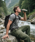 Man sitting by a river wearing Quick Release Tactical Belt for Work and Outdoors, 1.5 Inch Nylon Web With Heavy Duty Seatbelt Buckle, Grey.
