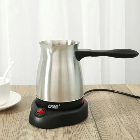 Turkish Coffee Maker 600ml Stainless Steel Electric Pot 110V on wooden table, ergonomic handle, cup beside, for home or travel use.