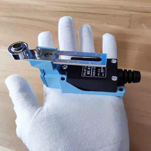 Limit Switch Travel Switch With Adjustable Roller Lever Arm in a gloved hand, CNC compatible metal TZ-8108 model.