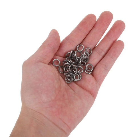 Hand holding stainless steel washers from Stainless Steel Flat Washers And Spring Lock Gasket 200 Piece Set For Furniture Fixes And Home Repairs