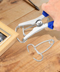 Premium Stainless Steel Miter Spring Clamps Kit With Heavy Duty Pliers For Picture Frames Wood Trim And Moldings In 24 Pieces Plus Storage Ring To Keep Your Studio Organized And Ready For Any Project. stainless miter clamp and pliers on wood frame