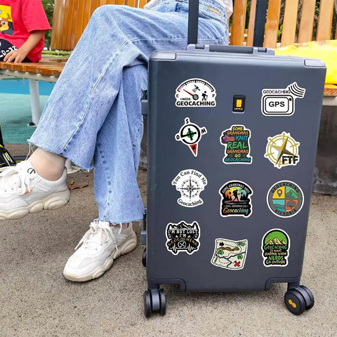 50 Piece Waterproof Geocaching Stickers Pack Vinyl Decals For Water Bottles Laptops Luggage Bicycles Skateboards Computers And More Rad Adventure Gear Decor displayed on suitcase